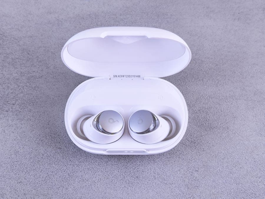 Small true wireless earbuds displayed in an open charging case
