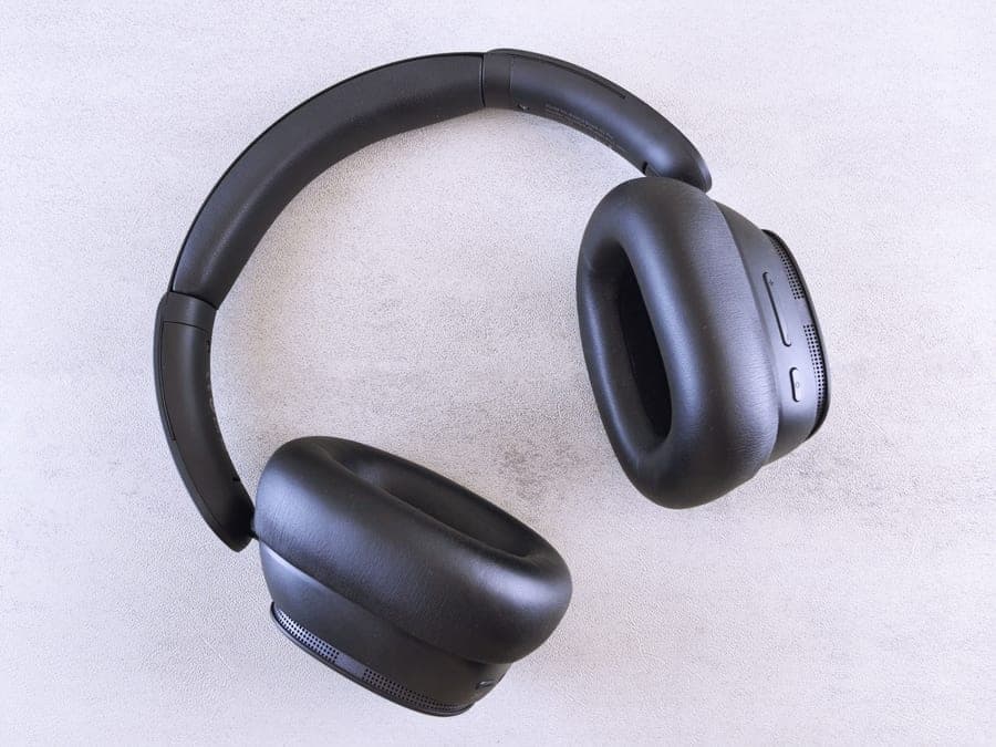 Black over-ear wireless headphones photographed flat on a light surface